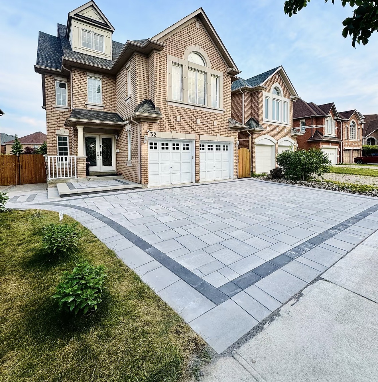 Completed interlock driveway with border banding, angled street view