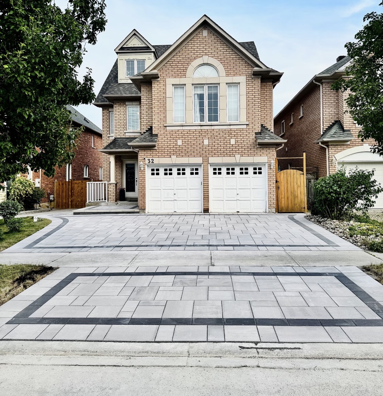 Completed interlock driveway with contrasting border banding, viewed head-on